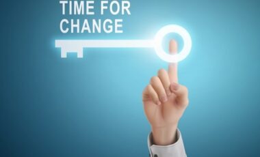 male hand pressing time for change key button over blue abstract background