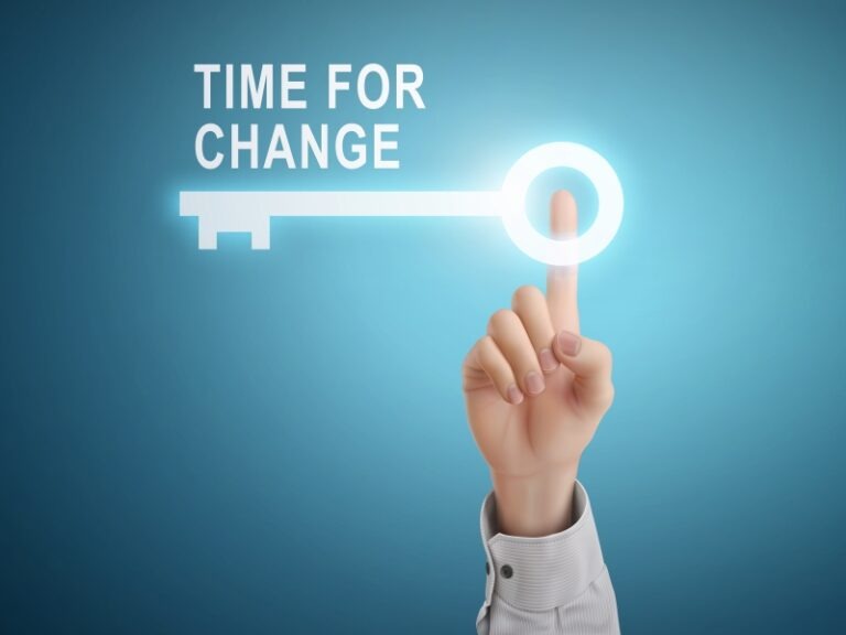 male hand pressing time for change key button over blue abstract background