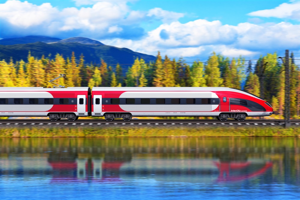 Creative abstract railroad travel and railway tourism transportation industrial concept: scenic summer view of modern high speed passenger train on tracks with lake or sea and mountains in background with motion blur effect