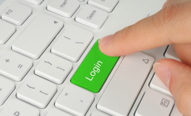 Hand pushing green login keyboard button
