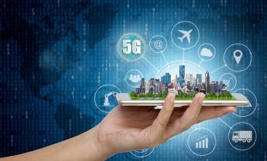 5G network wireless systems and internet of things, Smart city and communication network with Modern city model on smartphone in hand,  Connect global wireless devices.