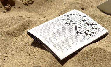 A crosswords game book on the sand